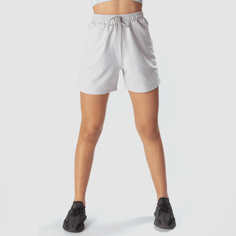 a fit woman wearing marl  light grey short with shoes black ,plus the background is light grey 
