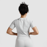 a back view for fit woman wearing  matching set crop top grey with short 