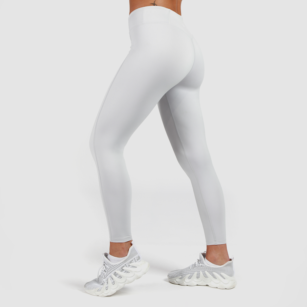 a fit woman stand at right and wearing legging grey with shoes white ,plus the background is light grey 