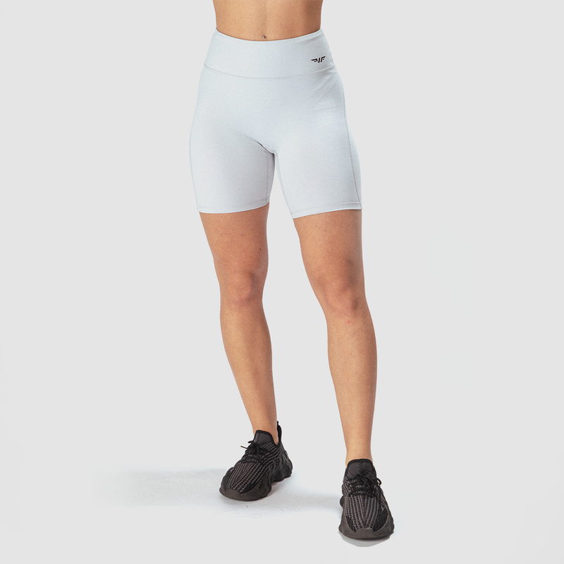  a fit woman wearing short grey with logo and sneakers black 
