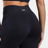 close up view for back view of woman wearing flared egging navy with logo white in half 