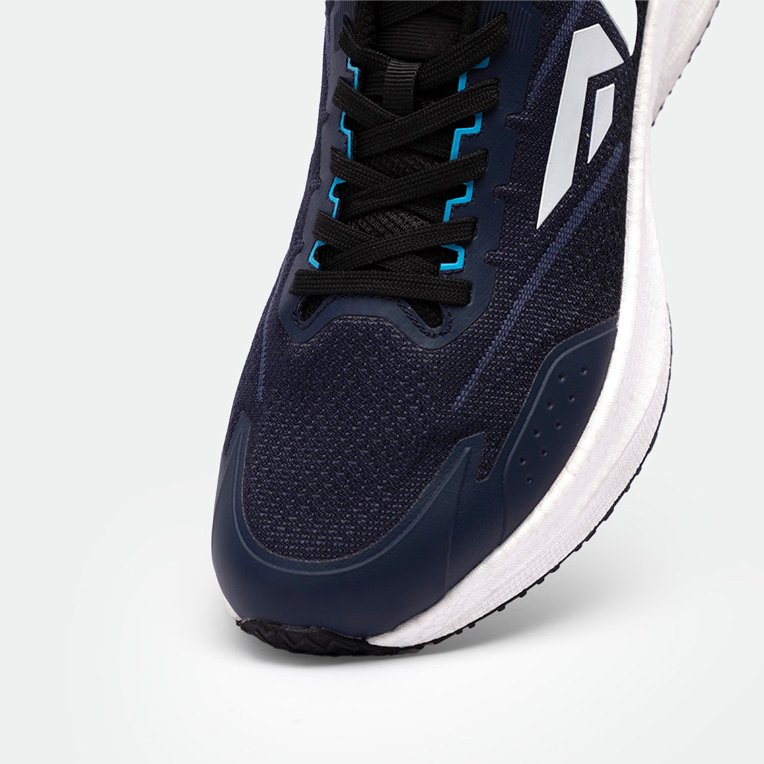 Close-up of a navy blue athletic shoe with black laces and blue accents. Features a white logo and white sole, conveying a sleek, sporty design.