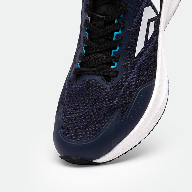 Close-up of a navy blue athletic shoe with black laces and blue accents. Features a white logo and white sole, conveying a sleek, sporty design.