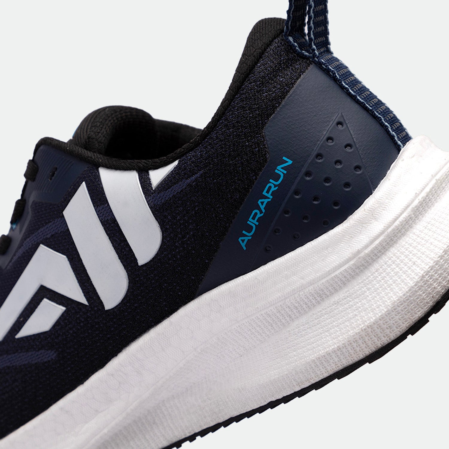 Close-up of a navy blue running shoe with sleek white accents and the word "AURARUN" in blue. The shoe has a thick white sole and a modern design.