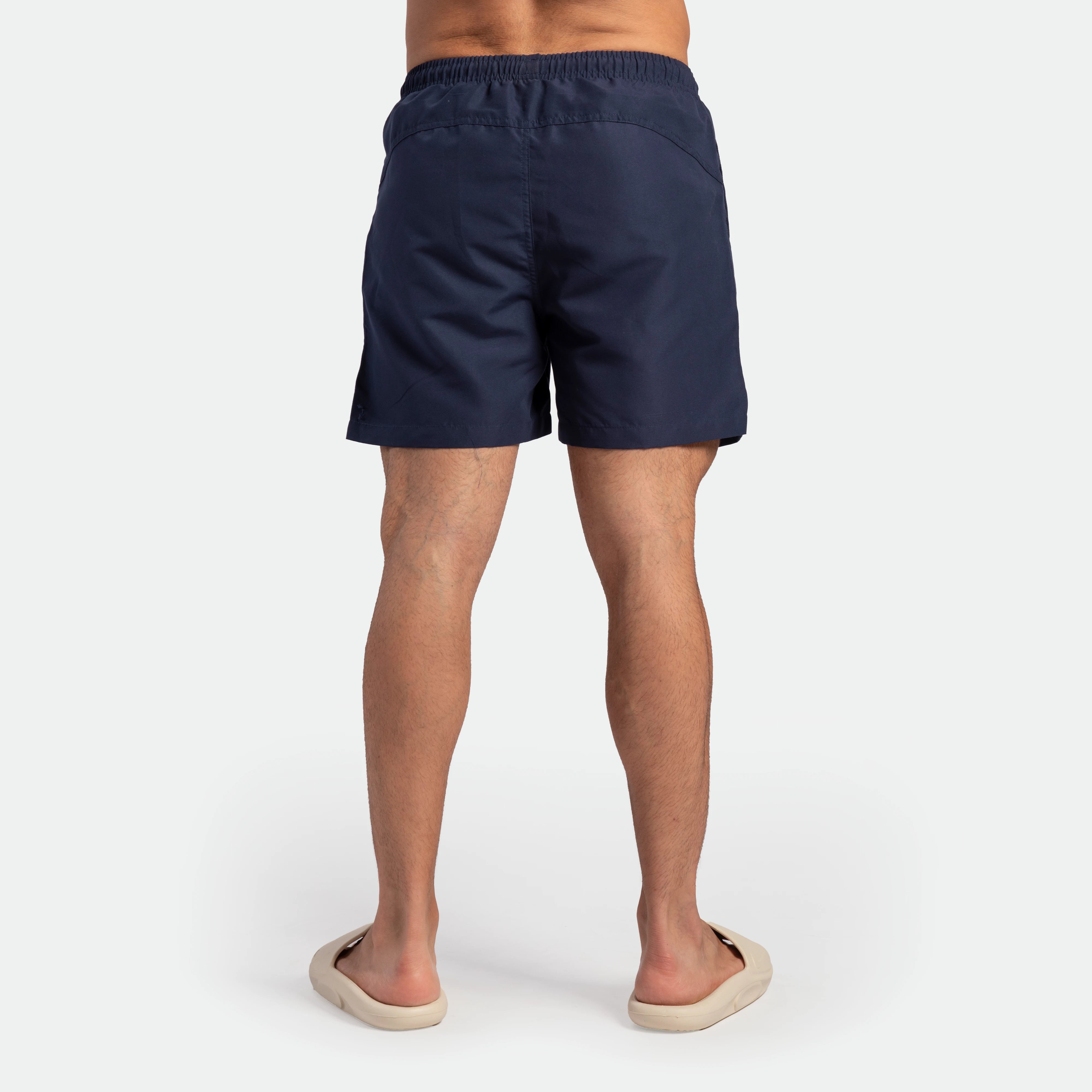 a back view for fit man wearing short navy blue 