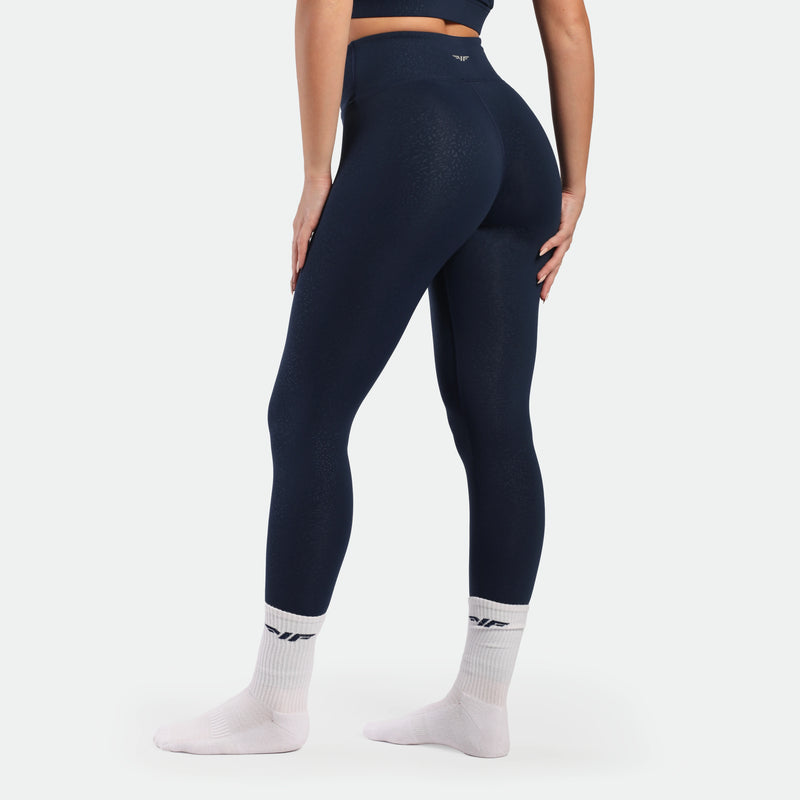 a back view for fit woman wearing legging navy blue terrazzo 