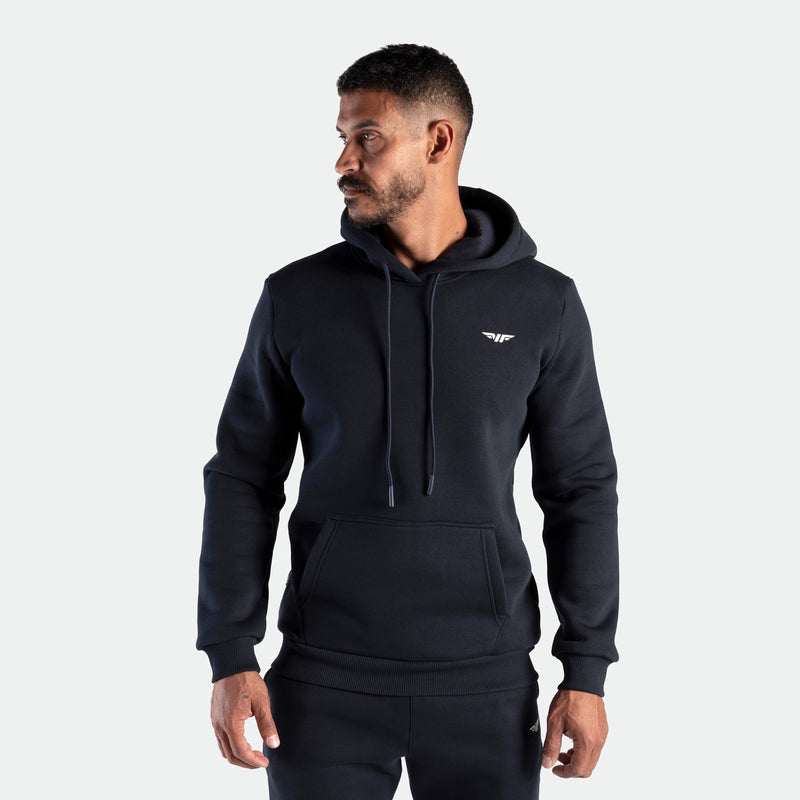 Man wearing a black hoodie on a plain background