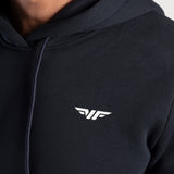 Black hoodie with a logo on a person wearing it.