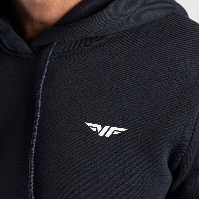 Black hoodie with a logo on a person wearing it.