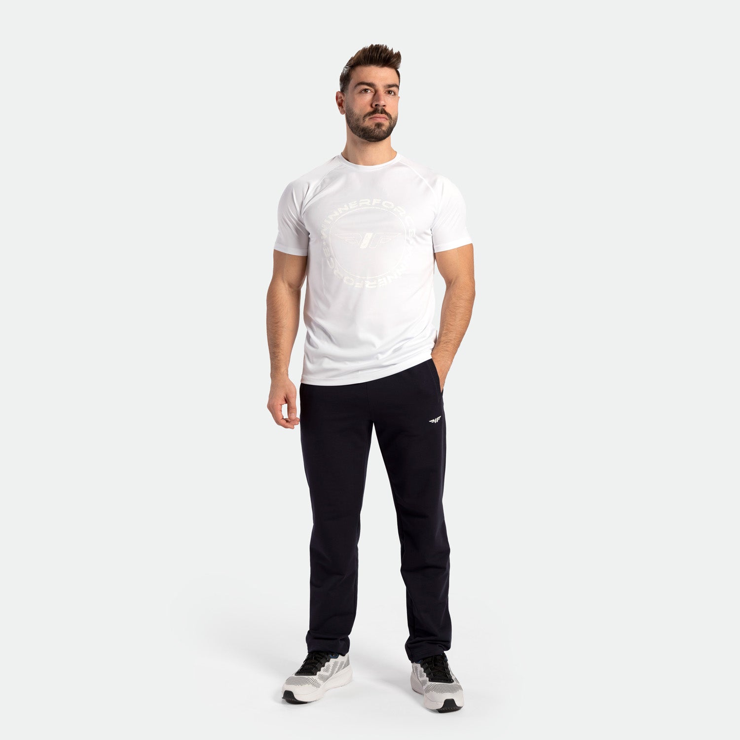 a fit man wearing  t-shirt white with logo and pants black with shoes ,plus the shoes 