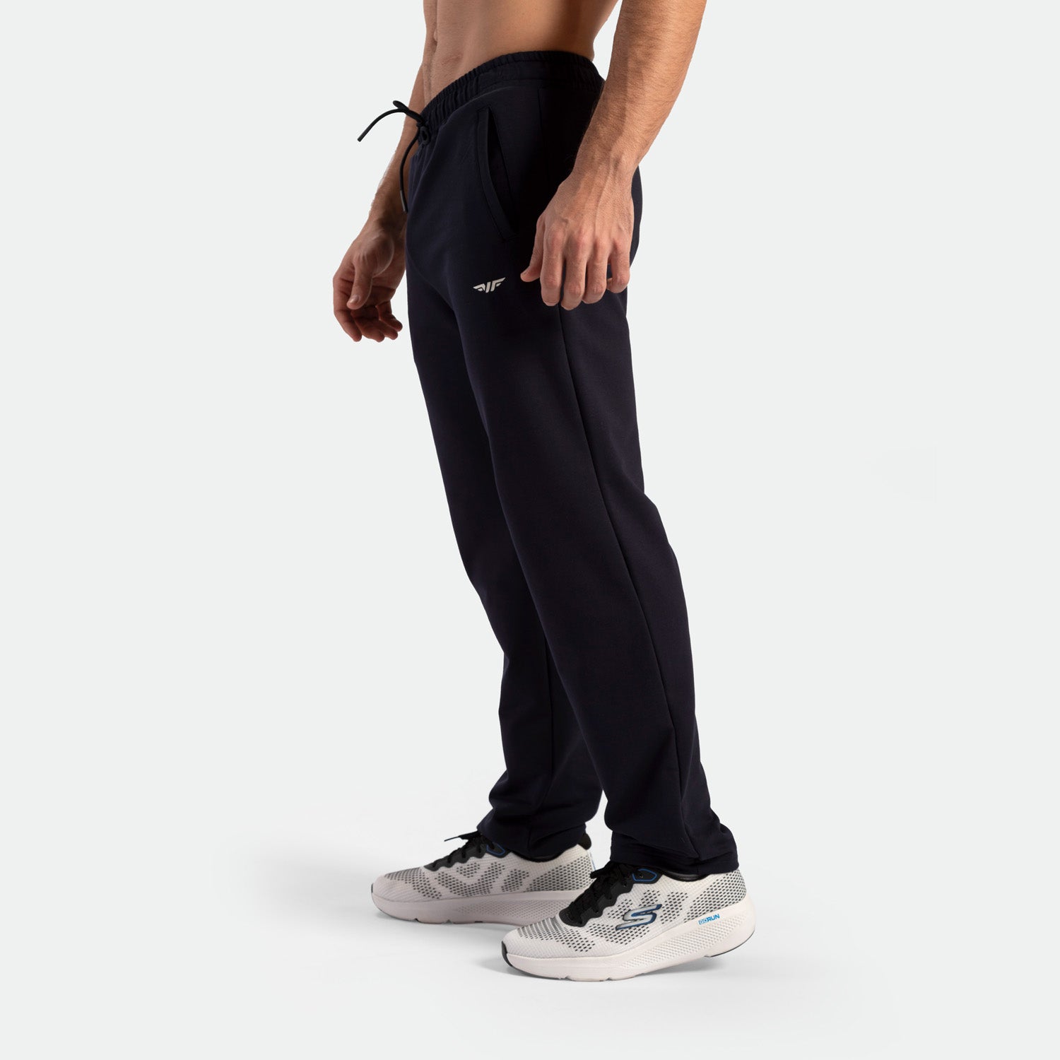 a fit man wearing pants black with shoes 