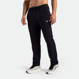 a fit man wearing pants black with shoes 