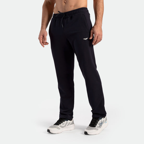 a fit man wearing pants black with shoes 