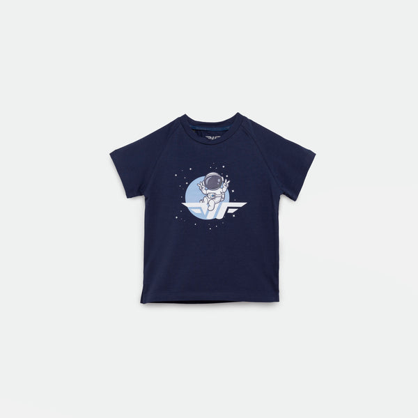 Navy blue short-sleeved t-shirt featuring a graphic of an astronaut floating in space with stars around, set against a circular blue background. The astronaut is positioned above a stylized wing logo.
