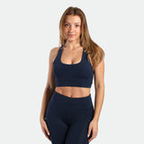a fit woman wearing matching set navy blue terrazzo ,bra and legging  