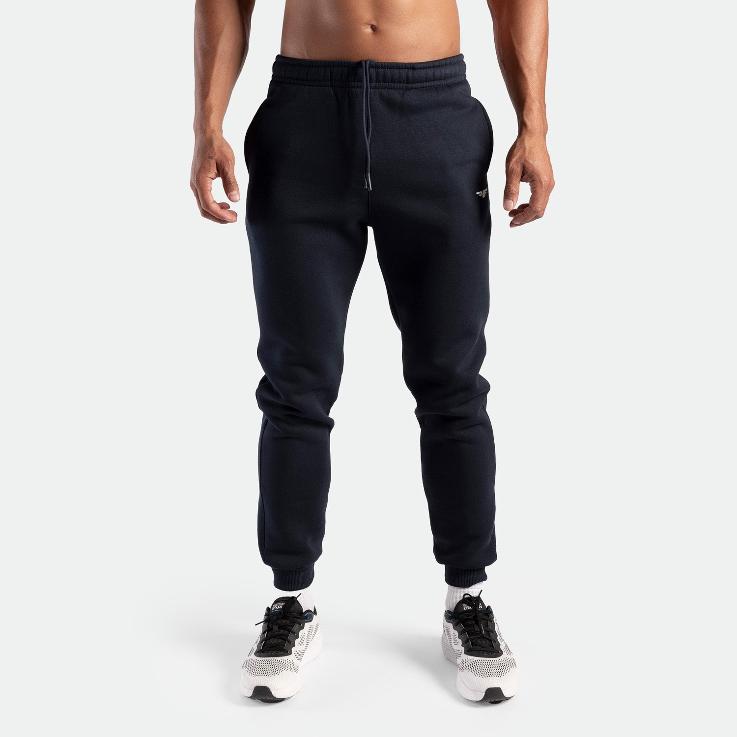 a fit man wearing pants navy with shoes  sports 