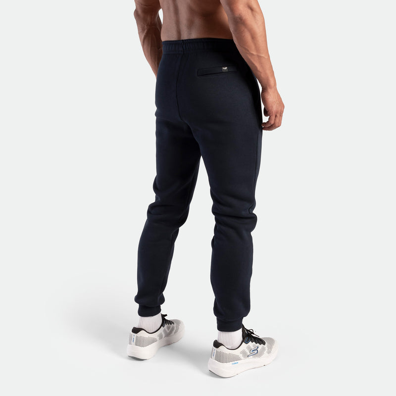 a back view for fit man wearing pants navy with shoes sports 