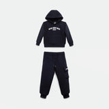 A black hooded sweatshirt and matching jogger pants set, laid flat on a light background. The hoodie features white text on the chest, and the joggers have a side pocket with a small label. The set has a casual and sporty design