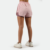 a back view for fit woman wearing  
 pink nectar short  2 in 1 with shoes white ,plus the background is light grey 