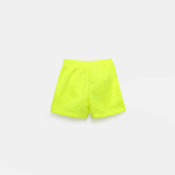 a back view for bright green short and background light grey 