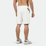 a back view for fit man wearing short white with shoes 