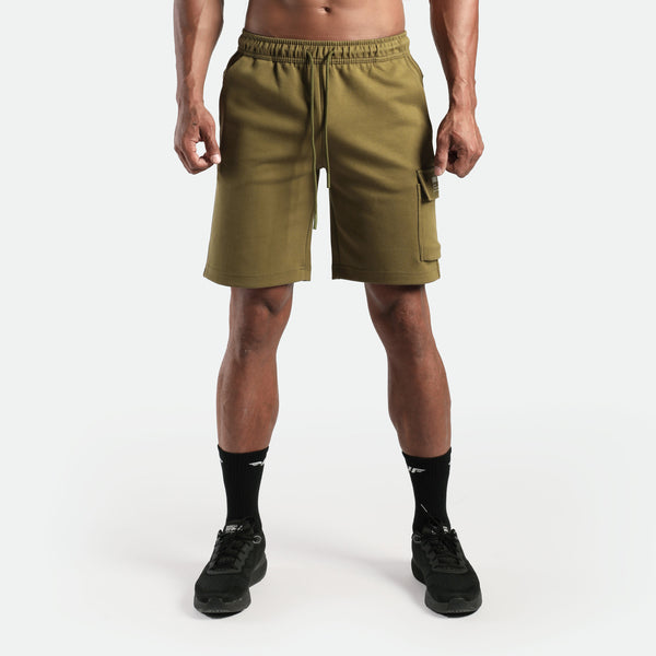 a fit man wearing short olive drop with socks and shoes black 