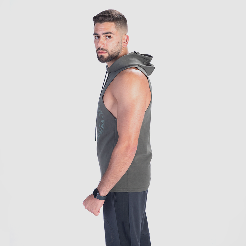 a fit man stand at right and wearing half hoodie with pants grey 