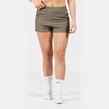 a fit woman wearing short olive -grey with socks white ,plus the background is light grey 