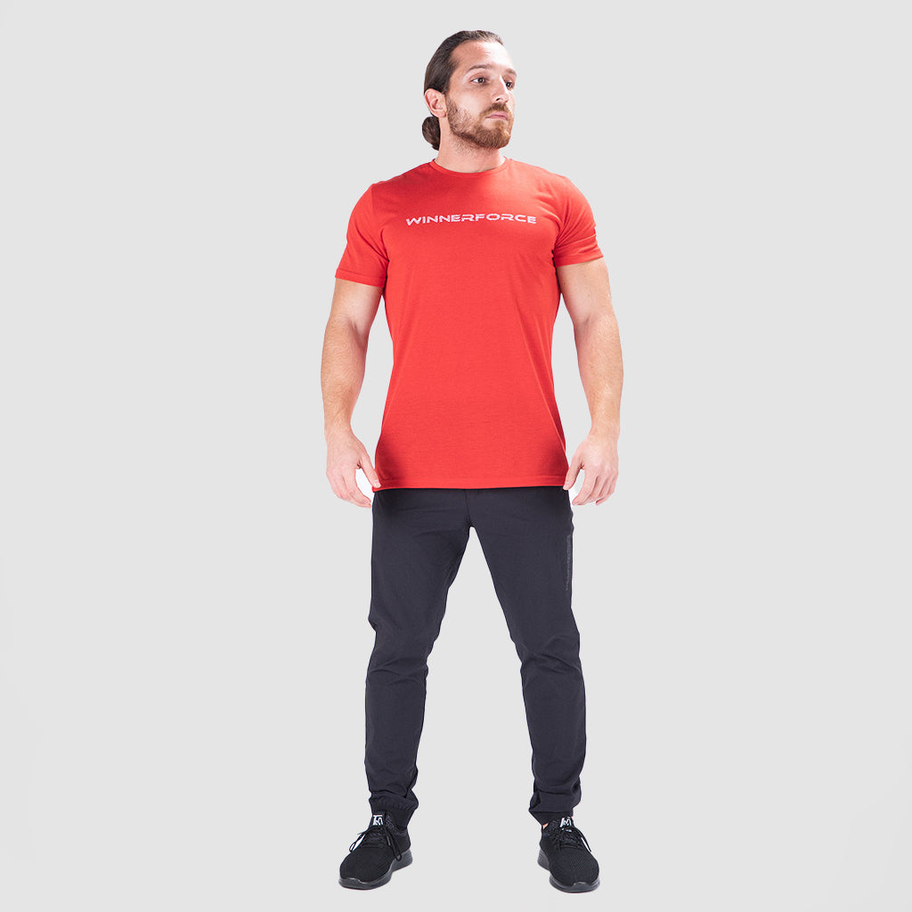 a fit man wearing t-shirt red with  logo 
 and pants black  plus sneakers 