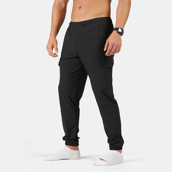 a fit man wearing cargo pants black with socks white 