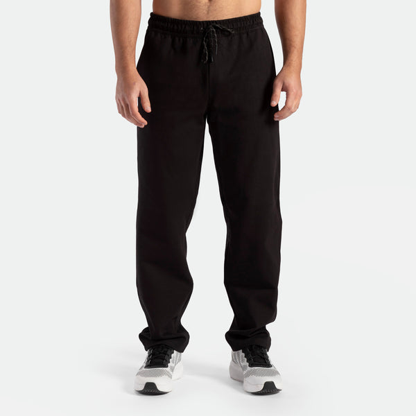 a fit man  wearing pants black with shoes 
