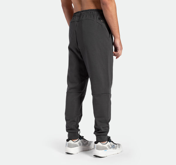 a back view for fit man wearing pants grey ebony with shoes sports 