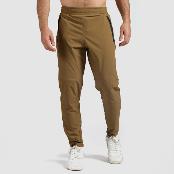 a fit man wearing pants khaki brown with shoes white 