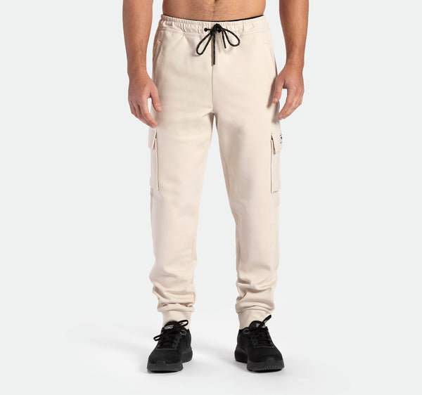 a fit man wearing jogger pants with shoes black 