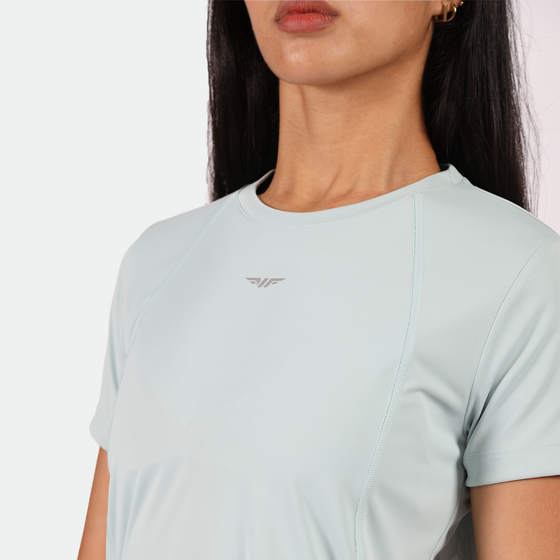 close up view for fit woman wearing t-shirt pastel blue with logo ,plus the background is light grey 