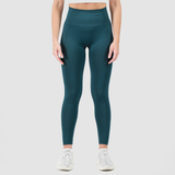 a fit woman wearing legging  seamless green with shoes with ,plus the background is light grey 