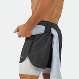 Shirtless man in athletic shorts with a towel tucked at waist. The focus is on the side view, displaying the textured fabric and lean physique.