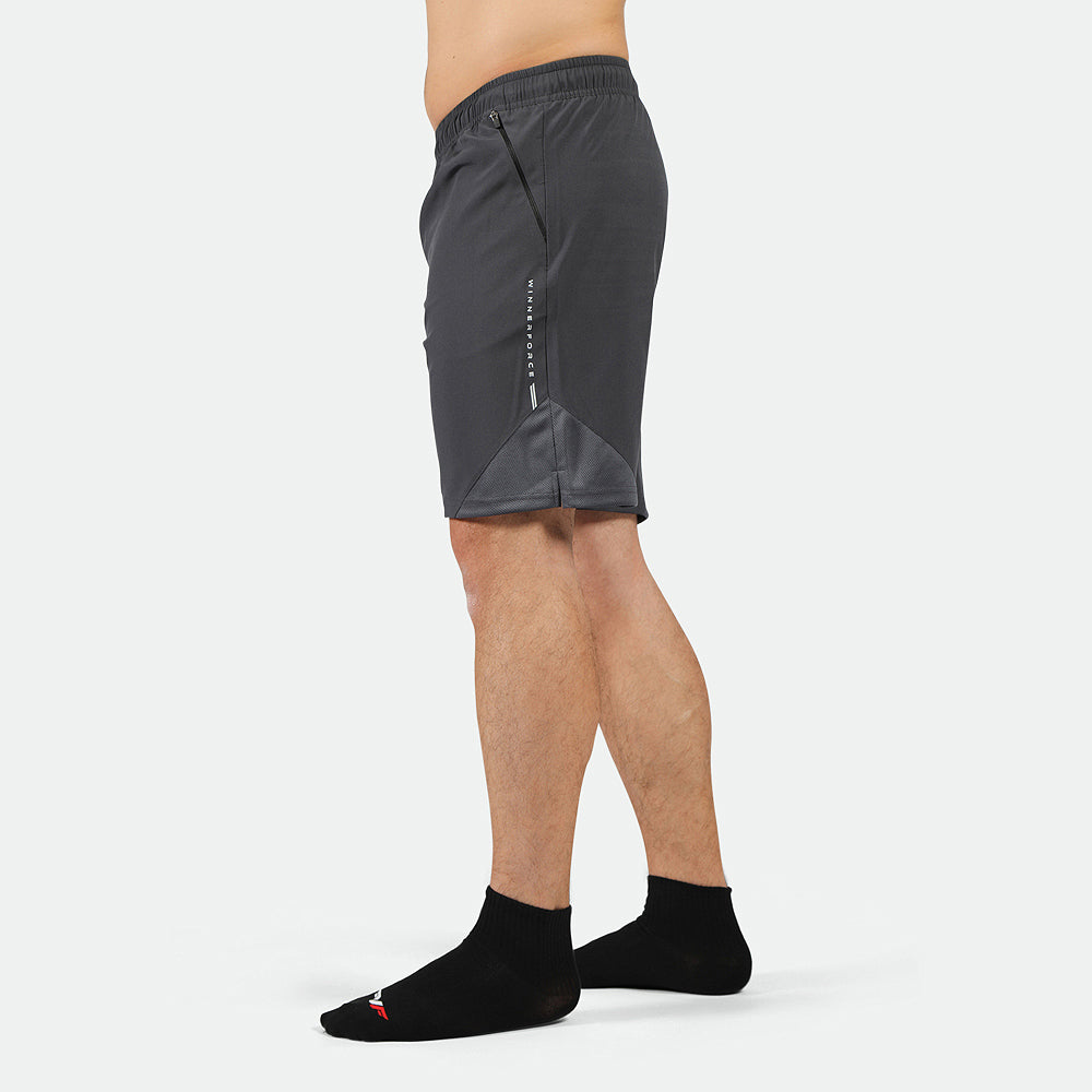 a fit man stand at right and wearing short  phantom grey with logo ,plus the socks black 