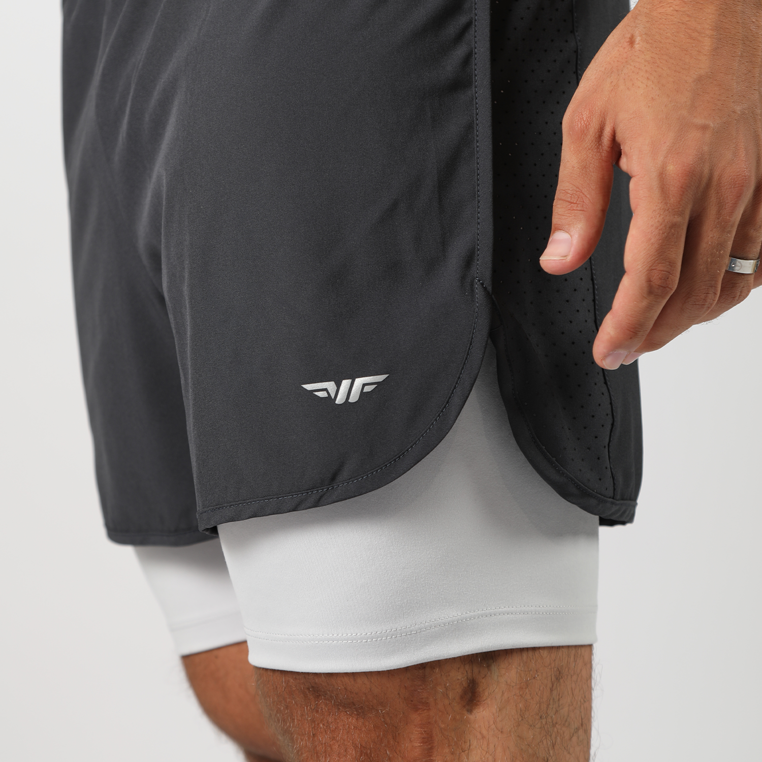 a fit man wearing short grey 2in 1 with logo 