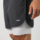 a fit man wearing short grey 2in 1 with logo 