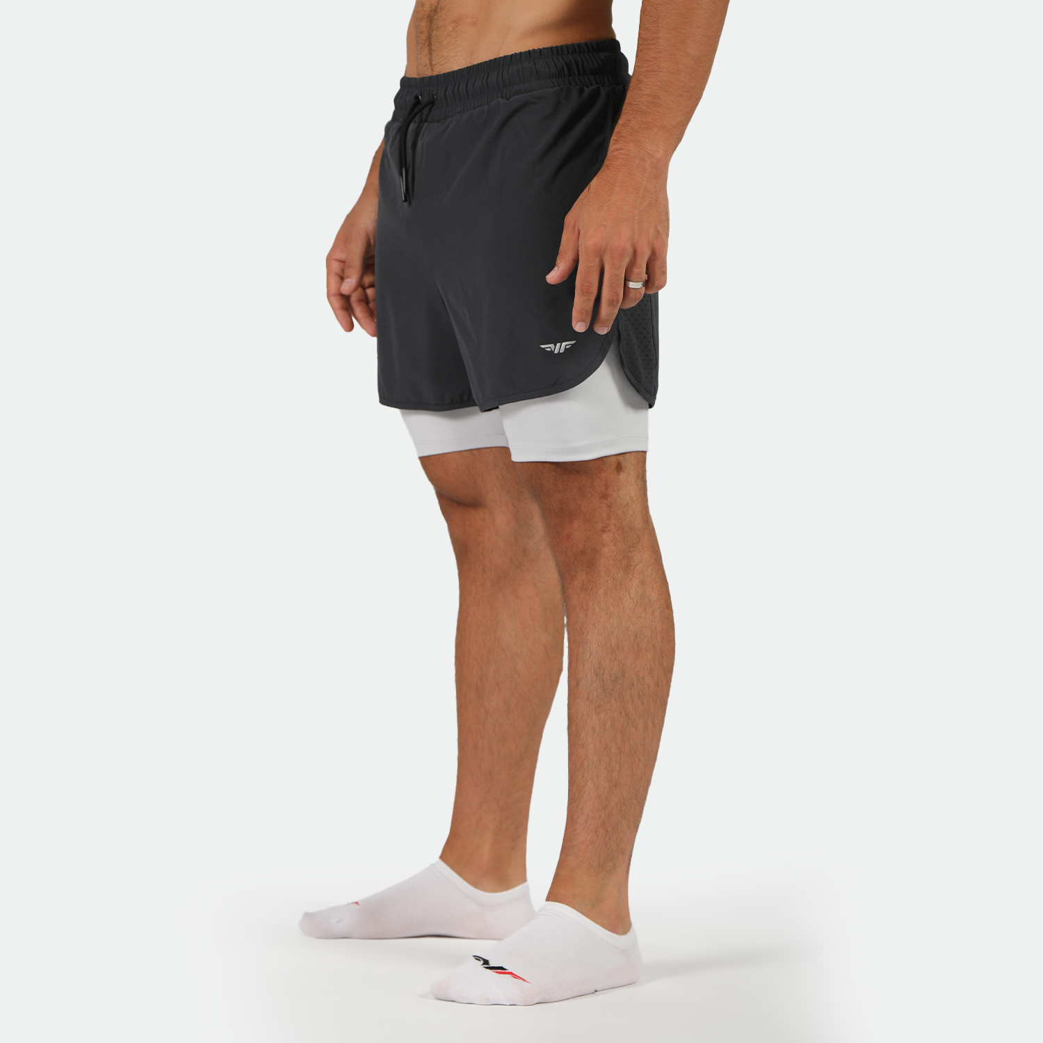 a fit man stand at right and wearing short phantom grey 2 in 1 with socks  white 
