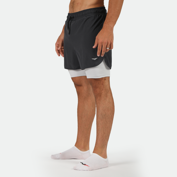 a fit man stand at right and wearing short phantom grey 2 in 1 with socks  white 