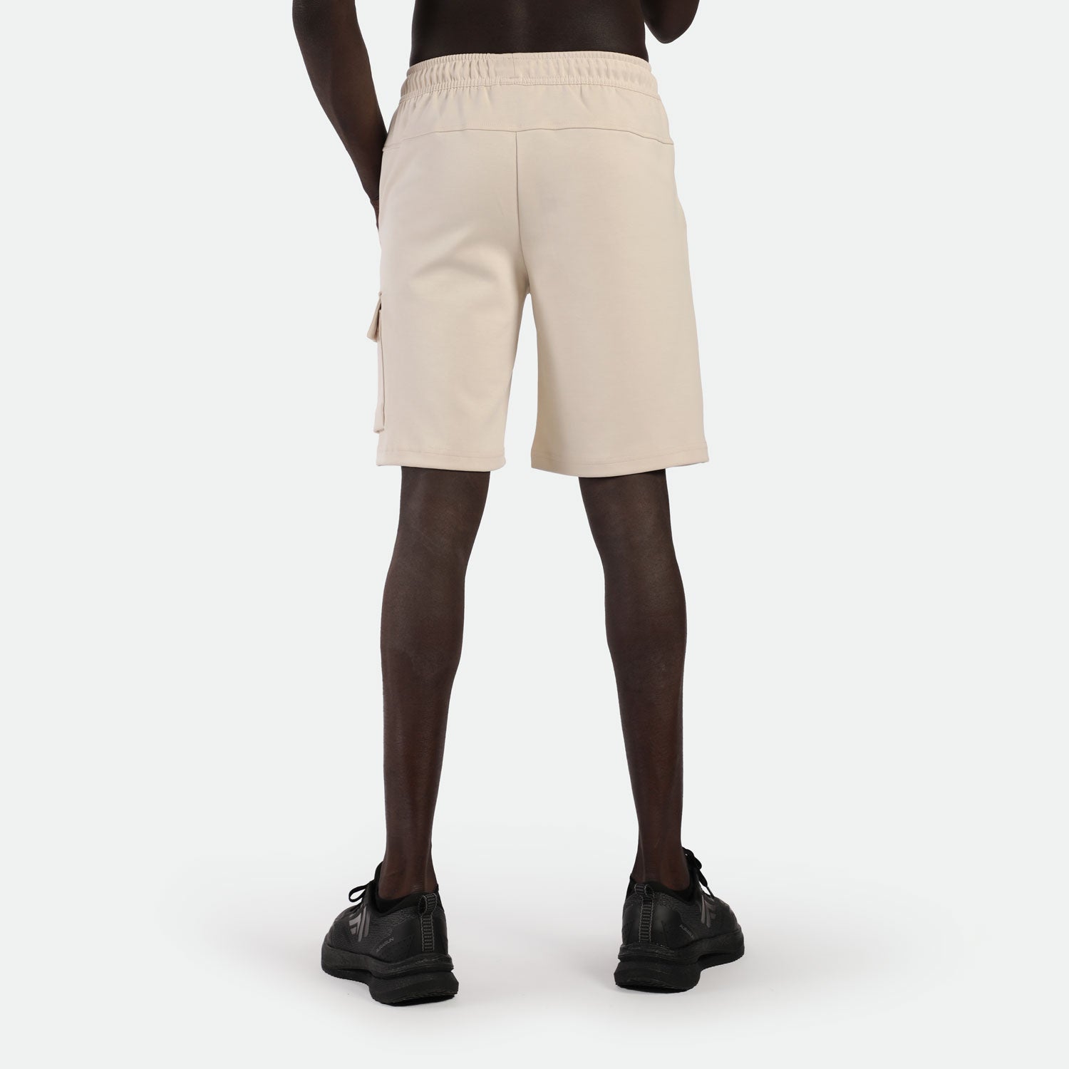 a back view for man wearing short beige with shoes black 