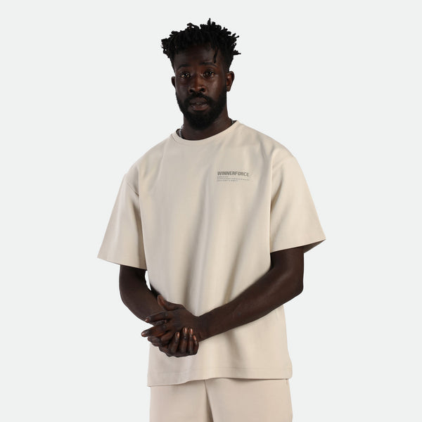 a fit man wearing matching set light beige  t-shirt with logo and short 