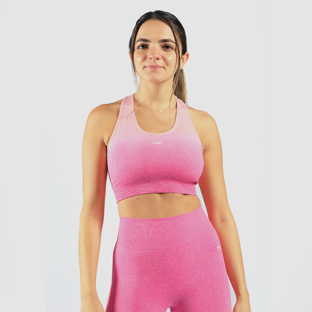 a woman wearing  matching  bra and legging  pink ,have same logo