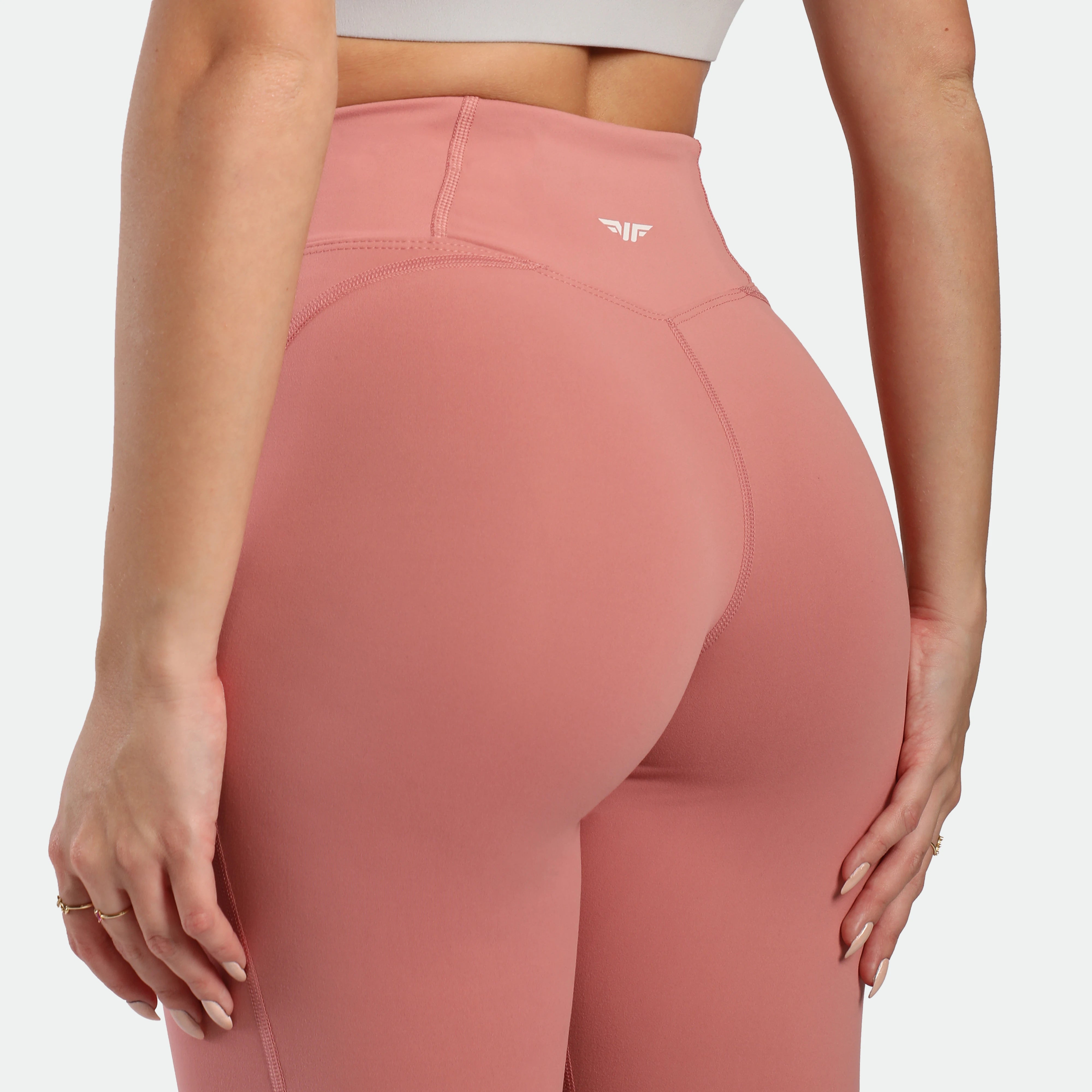 Pink leggings with a brand logo on a white background