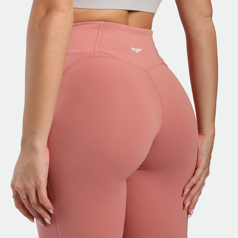 Pink leggings with a brand logo on a white background
