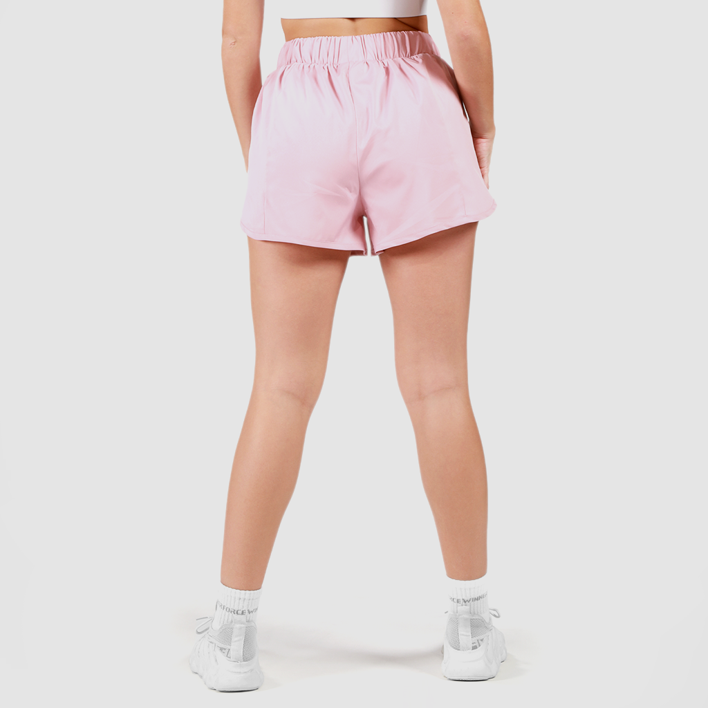 a back view for fit woman wearing short pink 2 in with shoes white ,plus the background is light grey 