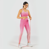 a fit woman stand with pose sports and look at down ,she wearing matching sport bra and legging pink ,shoes white 