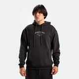 a fit man wearing matching set pirate black  hoodie with logo and pants 